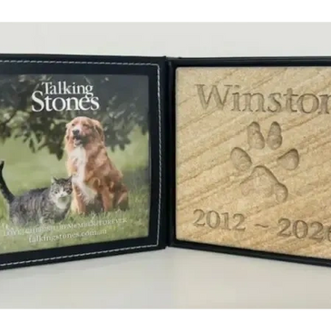 Memorial plaque for Winston with dog images and dates.