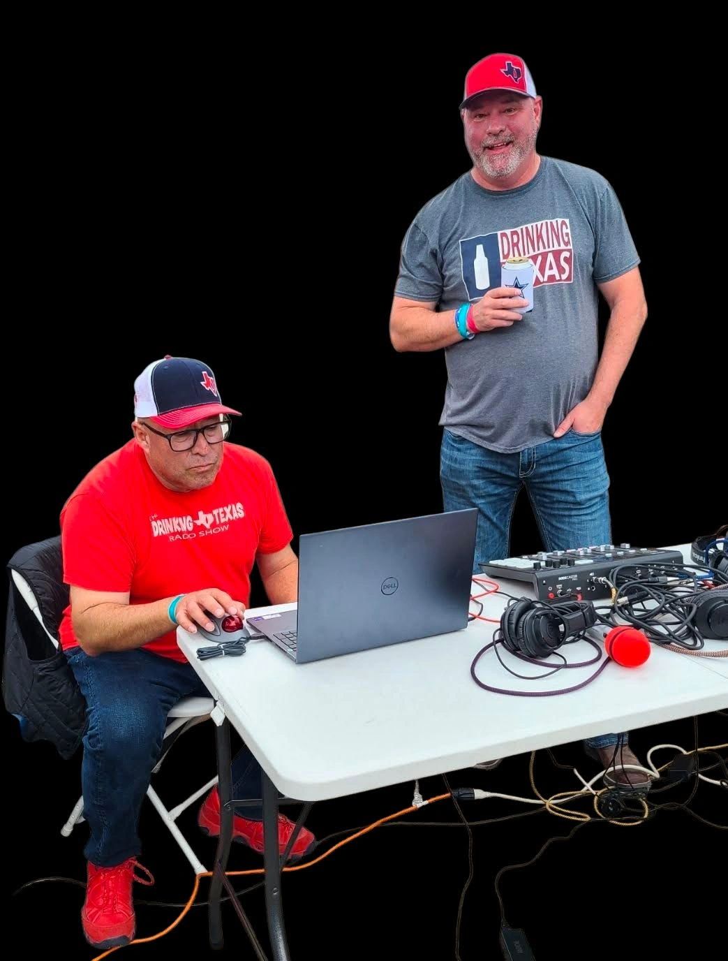 Two men with Texas-themed hats and shirts working at a podcast setup.