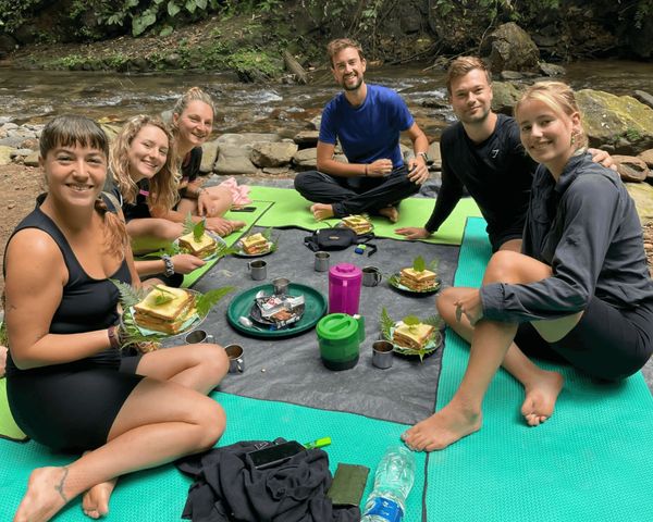 Group of people having breakfast on their jungle trek