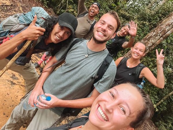 Smiling group of people while jungle trekking with Ecotourism Bukit Lawang