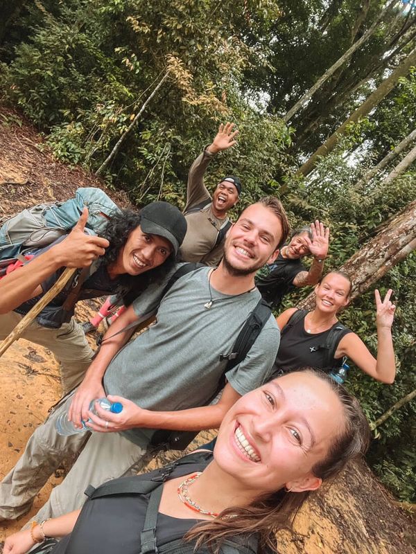 Smiling people during jungle trekking in Bukit Lawang