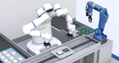 Two robotic arms assembling electronic circuit boards on a production line.
