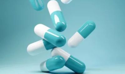 Blue and white capsules floating in the air.