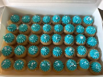 A box of 40 mini cupcakes with blue frosting and silver decorations.