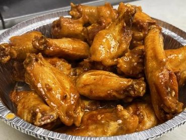 A tray full of glazed chicken wings.