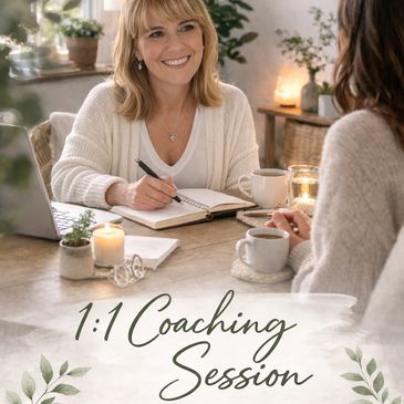 Two women engaged in a warm 1:1 coaching session at a cozy table.