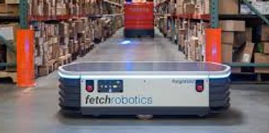A Fetch Robotics autonomous warehouse robot moving between shelves.
