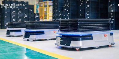 Autonomous robots transporting goods in a warehouse setting.
