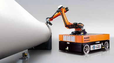 KUKA robotic arm inspecting or working on a large cylindrical object.