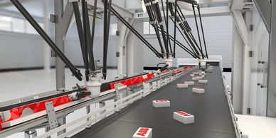 Robotic arms sorting packages on a conveyor belt in a modern factory.