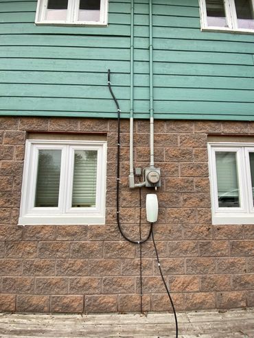 Clean outdoor Tesla Level 2 EV charger installation in the GTA by Green Cables Tech.