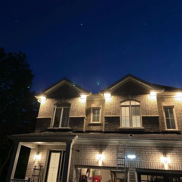 Modern outdoor LED potlight installation and soffit lighting for a residential home in Aurora by Green Cables Tech Electric.