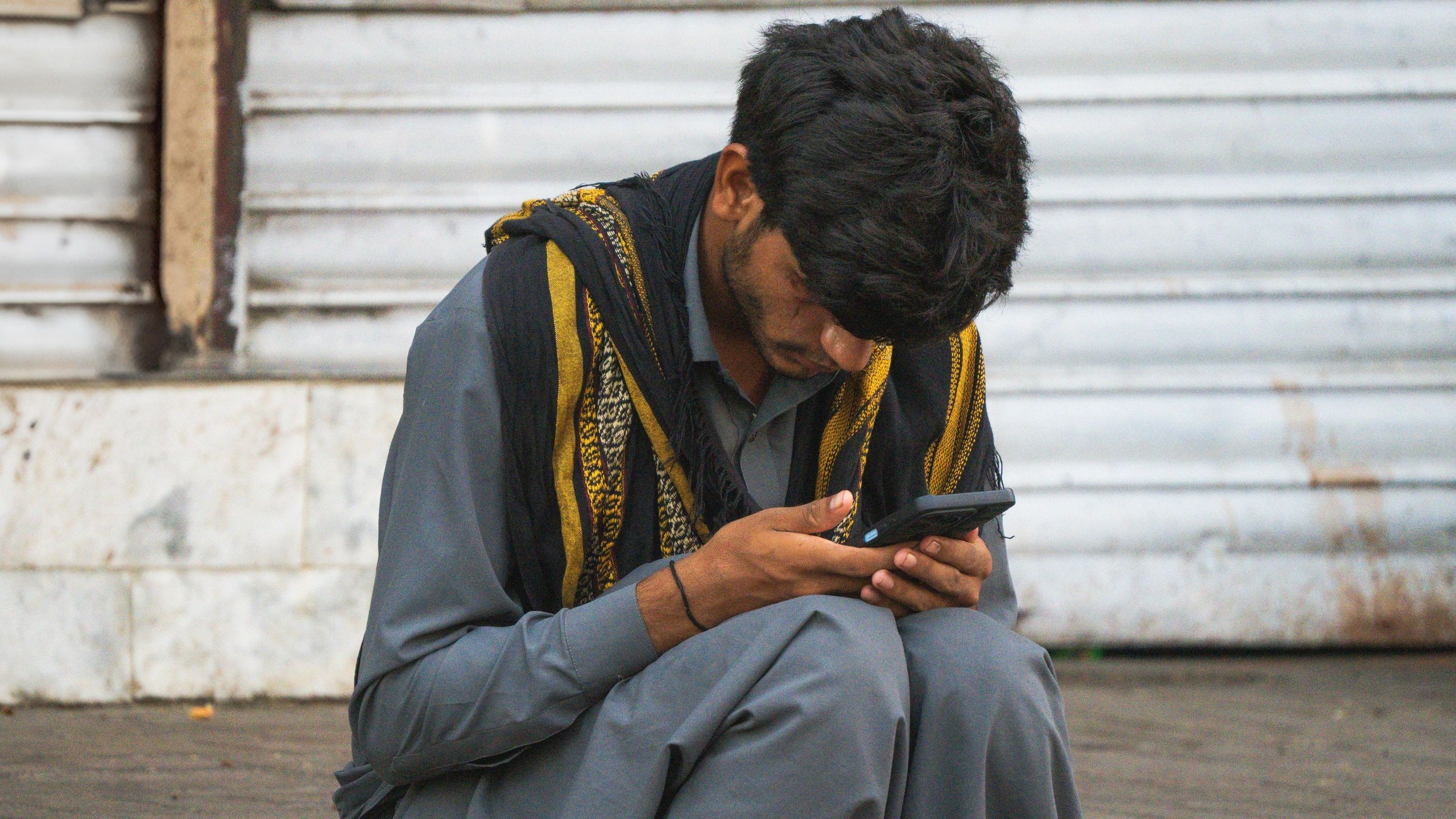 Man sitting and looking on his mobile