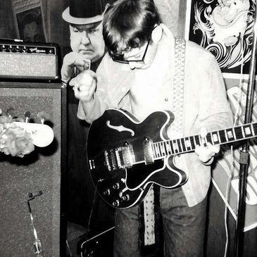 Musician passionately playing electric guitar in a retro setting.