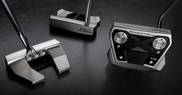 Three modern Scotty Cameron putters with sleek metallic finishes on a dark surface.