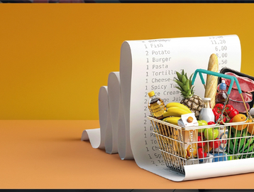 A shopping basket filled with groceries and a long receipt behind it.