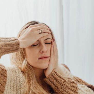 Woman feeling headache and discomfort.