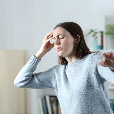 Woman struggling with a headache or dizziness.