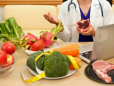 Doctor promotes healthy eating with fresh fruits and vegetables.