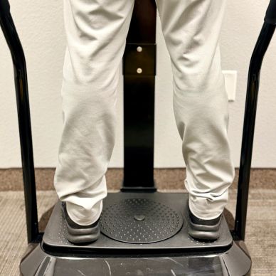 Person standing on a vibration plate machine.