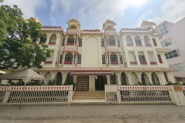 Facade of a traditional Indian-style building with ornate windows and arches.