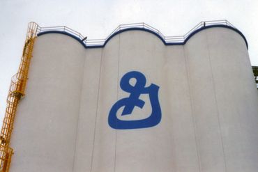 Sign Painting on Exterior Silo. General Mills logo is two stories tall!