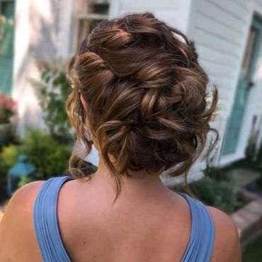 the back of a girls head showcasing her updo that was just done for a wedding