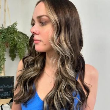 blond highlights added to a girls hair inside of a hair salon