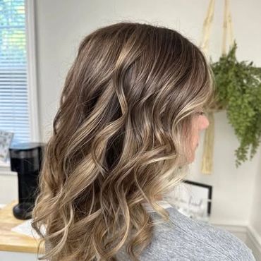 light brown hair color with blonde highlights taken inside a hair salon