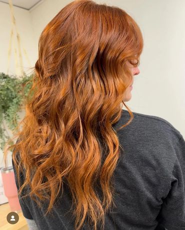 the back of a head showcasing the amber color that was added to her freshly cut and styled hair