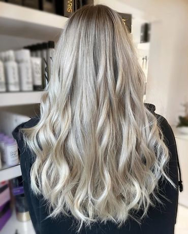 the back of a girls head showcasing the platinum blonde haircolor that was done