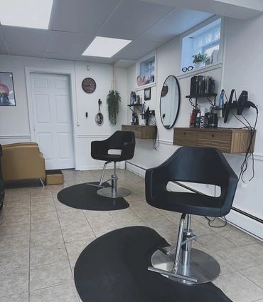 a couple of empty chairs inside of a hair salon in penfield ny