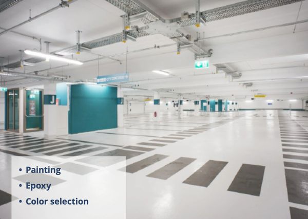 Spacious, brightly lit parking garage with clear markings and signs.