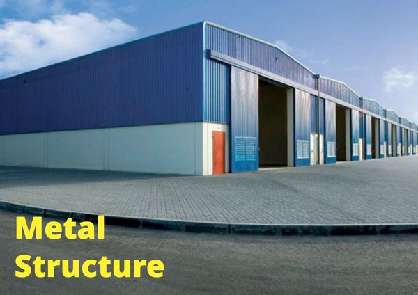 Large blue metal warehouse with multiple open doors under a clear sky.