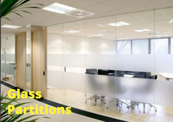 Modern office with frosted glass partitions and wooden doors.