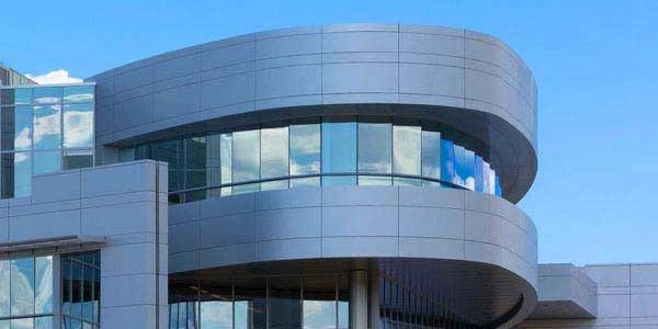 Light gray ACM wall panels on a curved surface