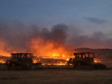 Fire contractors working with fire crews to stop fire using dozers