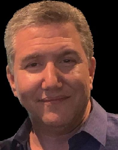 Portrait of a middle-aged man with a slight smile and gray hair.