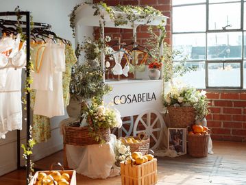 Charming indoor floral and lingerie display with natural light and rustic decor.