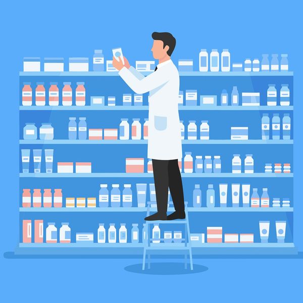 Pharmacist organizing medicine bottles on shelves while standing on a step ladder.