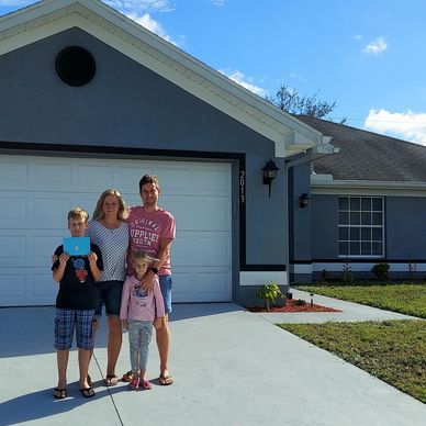 Family in front of house