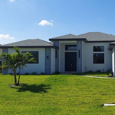 modern house with a palm tree in the front yard