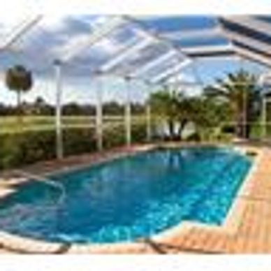 pool with enclosure and palm trees