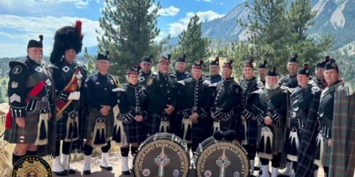 Colorado Emerald Society Pipe and Drum Band poses in the Rocky Mountains.