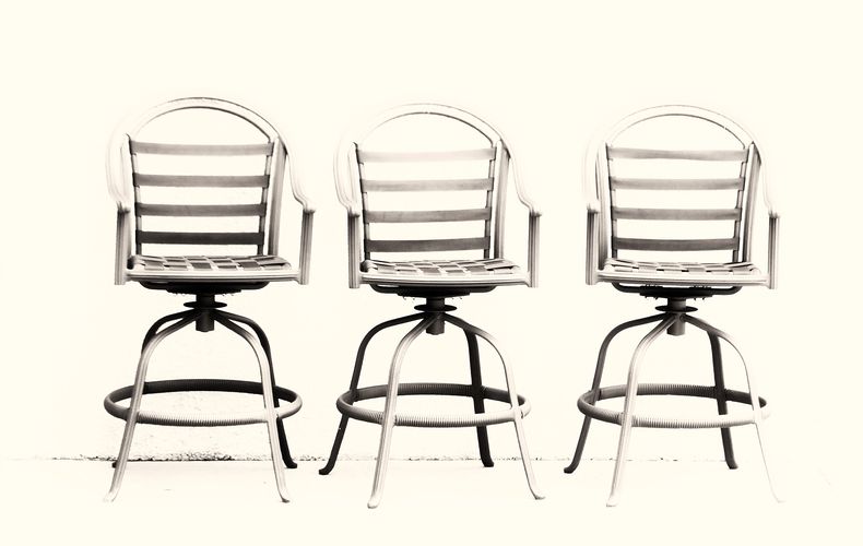 Contemporary, high key, minimalist photograph image of three chairs.