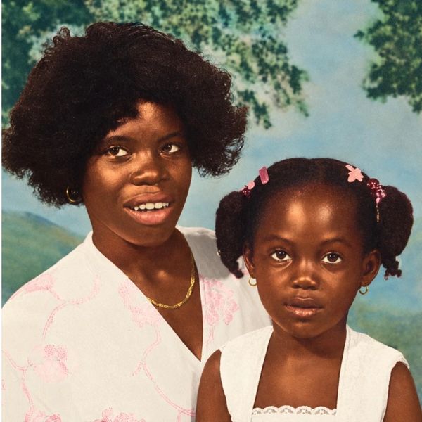 Woman and young girl posing together.