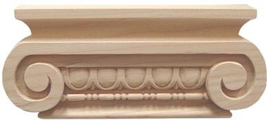 Intricately carved wooden architectural ornament with scrolls and bead details.