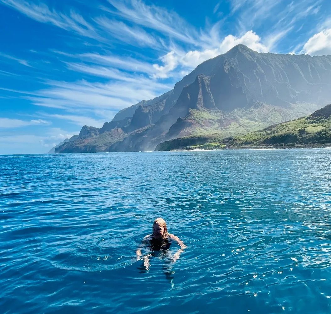 Lynda Beth swimming off the Na Pali Coast in Kauai, Hawaii.