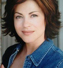 Portrait of a woman with short brown hair wearing a denim jacket.