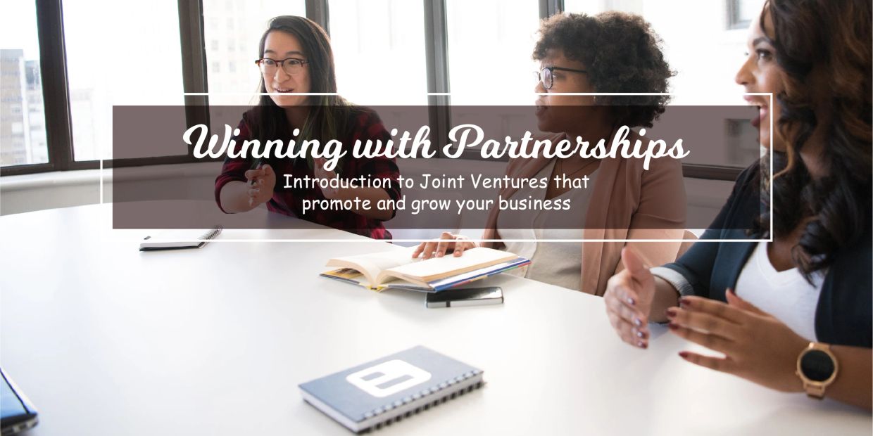 Three women engaged in a business meeting about joint ventures and partnerships.